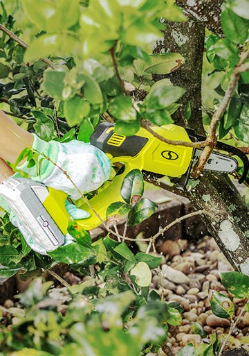Sun Joe 24-volt Cordless Handheld Pruning Chain Saw cutting a branch off a tree.